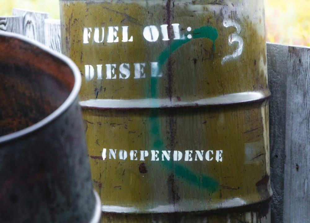 A weathered fuel oil barrel labeled "Diesel" and "Independence" in a rural setting.