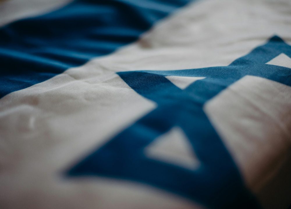 Detail of the Israeli national flag highlighting the Star of David, emphasizing its cultural significance.