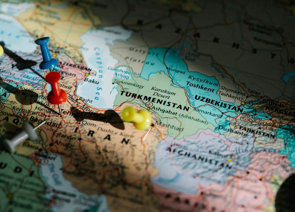 Colorful pushpins marking locations on a detailed map of Central Asia.